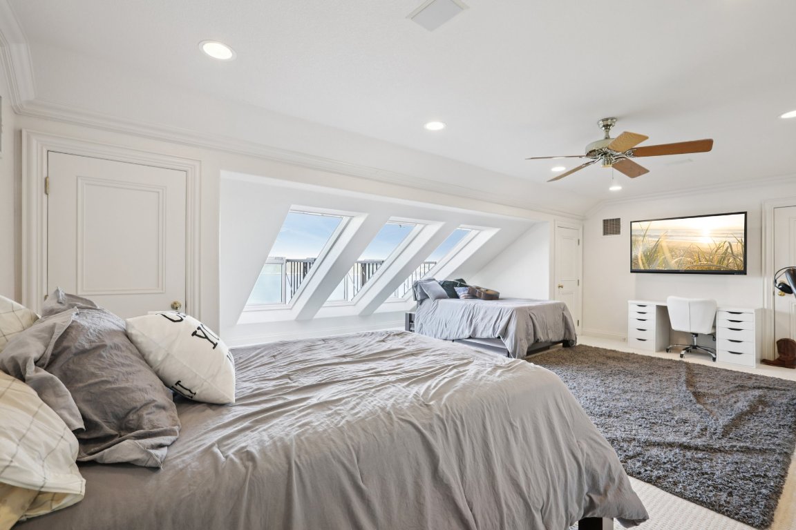 14701 Hornsby Hill Road Austin, TX 78734 - Photo 31 of 40 a bedroom with a bed and a chandelier