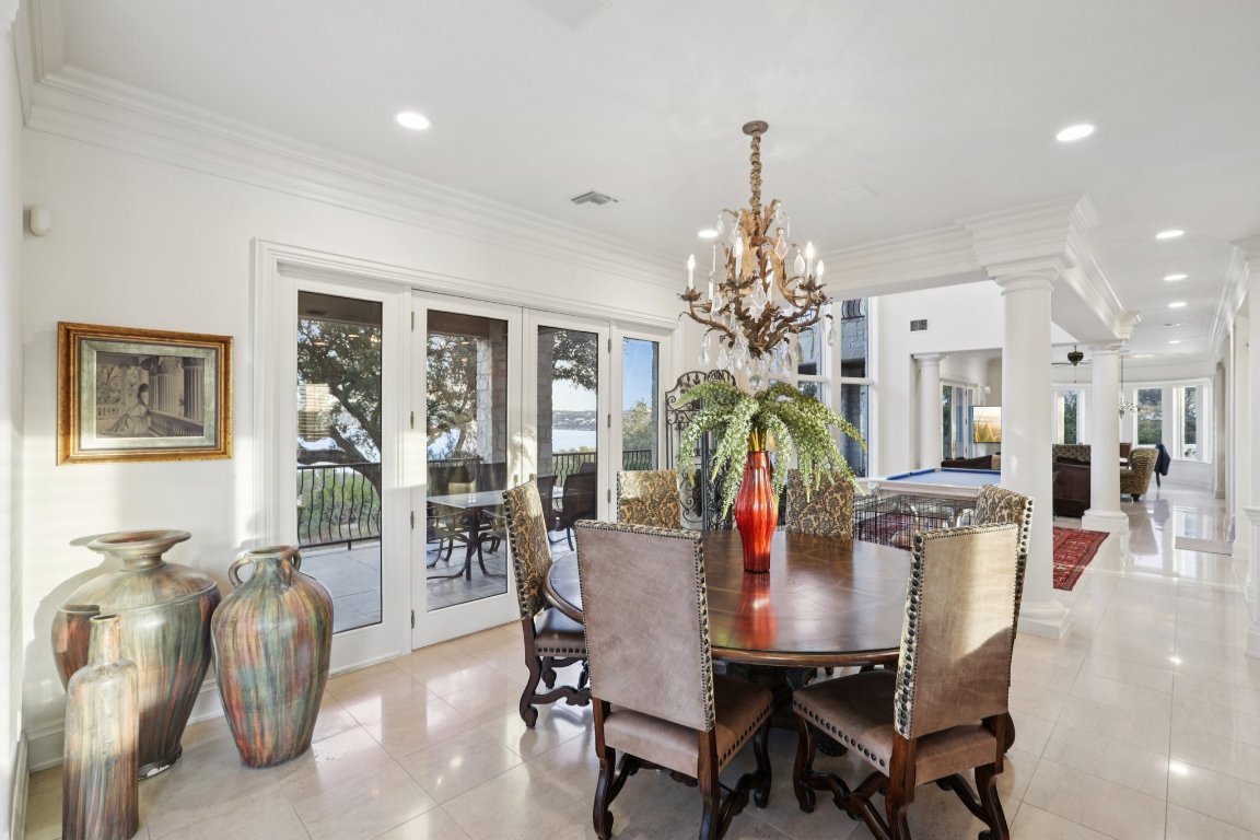 14701 Hornsby Hill Road Austin, TX 78734 - Photo 8 of 40 a view of a dining room with furniture and chandelier