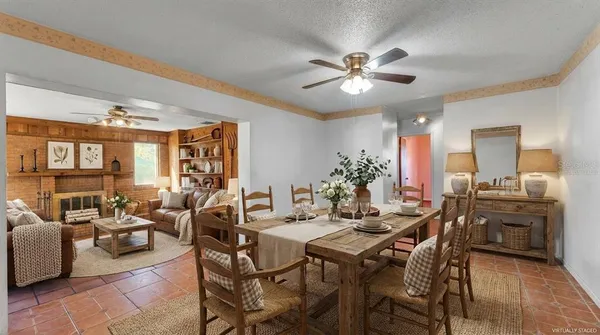 a view of a dining room with furniture and chandelier
