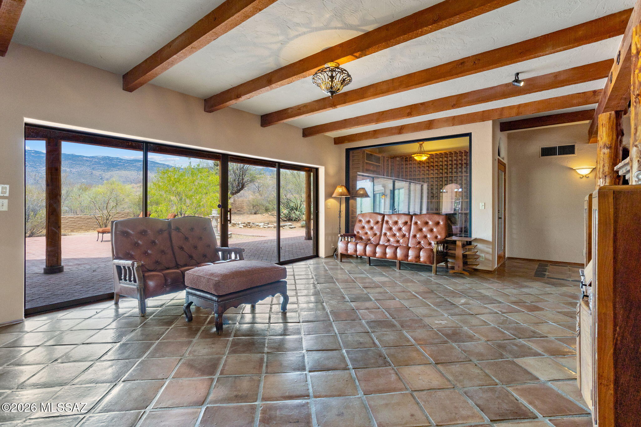 7171 South X9 Ranch Road Vail, AZ 85641 - Photo 12 of 50 Chandelier casts a beautiful glow onto ceiling! Leather sofa & loveseat & ottoman included.
