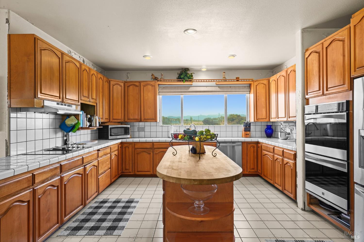 5267 Old Sonoma Road Napa, CA 94559 - Photo 14 of 24 a kitchen with stainless steel appliances a sink stove refrigerator and cabinets
