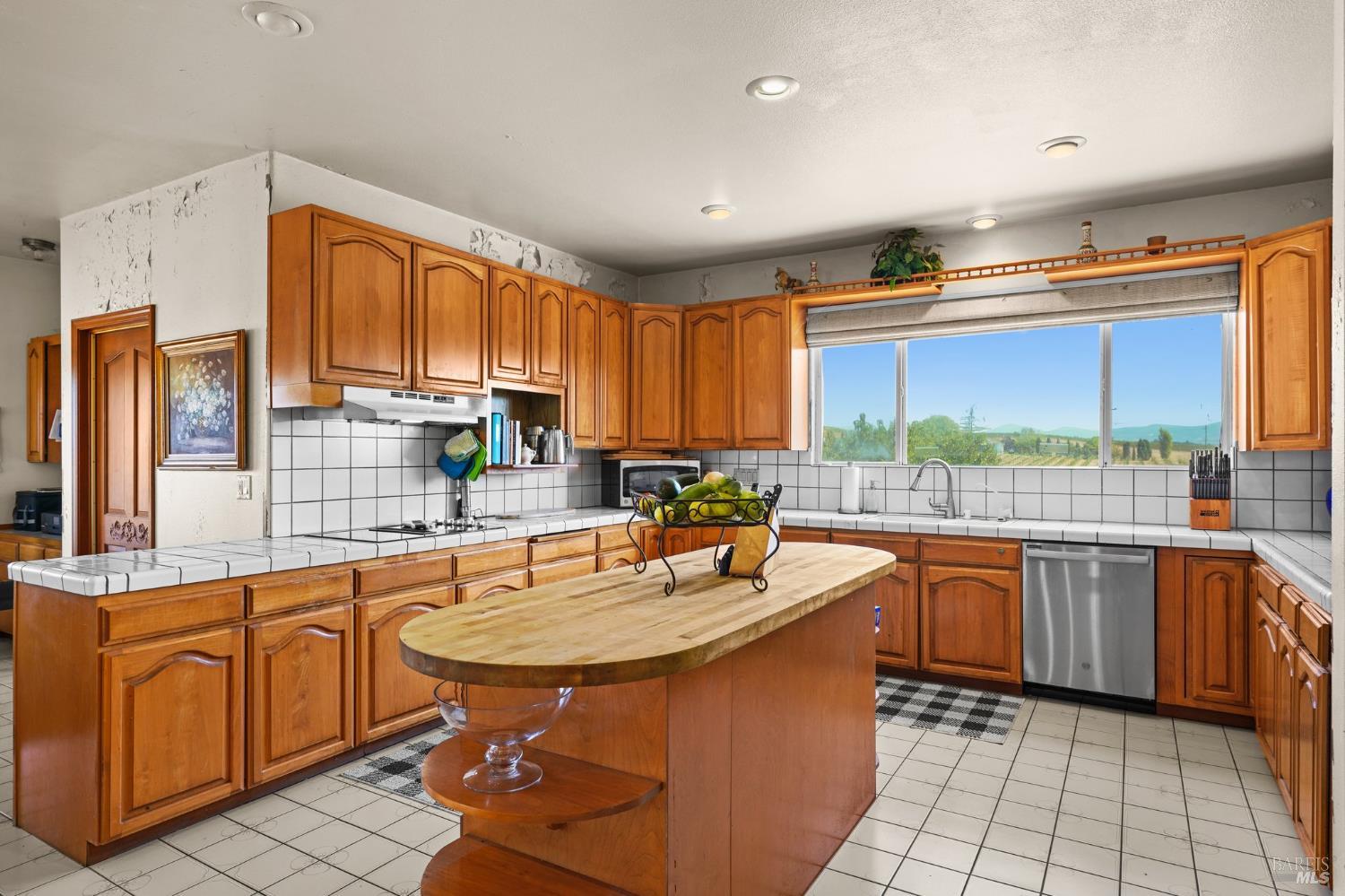 5267 Old Sonoma Road Napa, CA 94559 - Photo 15 of 24 a kitchen with kitchen island granite countertop a sink stainless steel appliances and cabinets