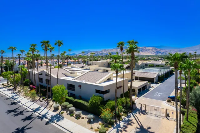 a view of a patio with table and chairs potted plants
