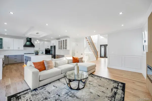 a living room with furniture and kitchen view