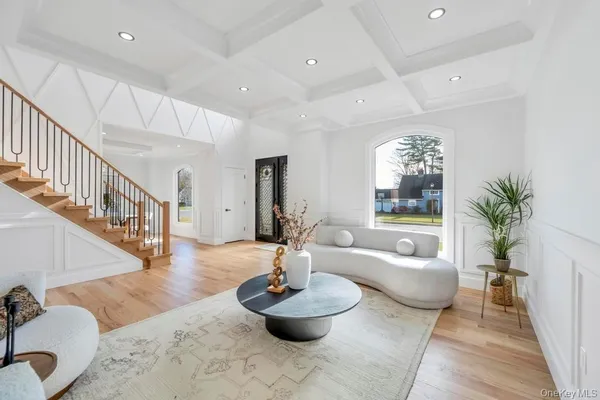 a living room with furniture and a chandelier