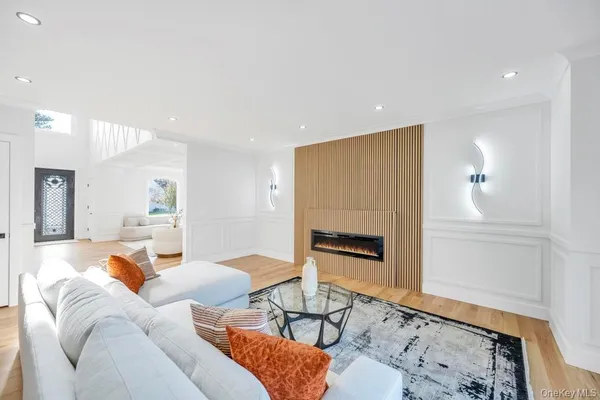 a living room with furniture wooden floor and a fireplace
