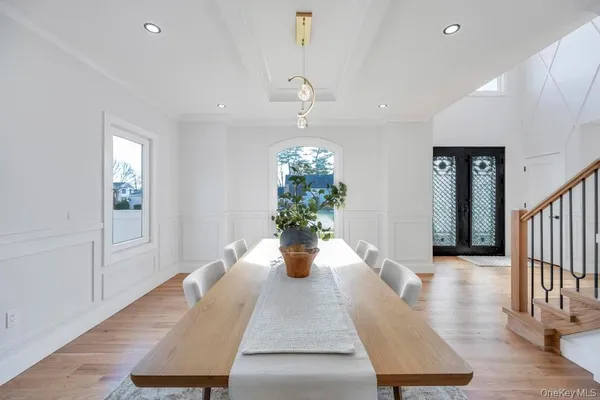 a dining room with wooden floor and potted plant