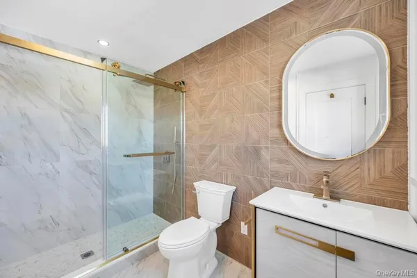 a bathroom with a sink mirror toilet and shower