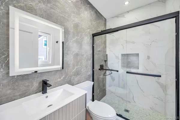 a bathroom with a sink toilet and shower