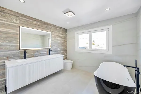 a bathroom with 2 sink and a mirror