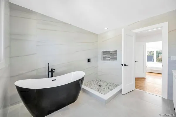 a spacious bathroom with a bathtub and shower