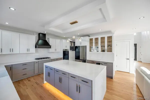 a large kitchen with stainless steel appliances granite countertop a stove and a sink