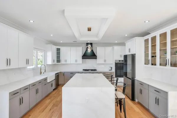 a kitchen that has a lot of cabinets in it and wooden floors