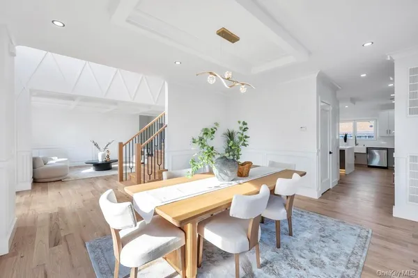 a dining room with furniture and wooden floor