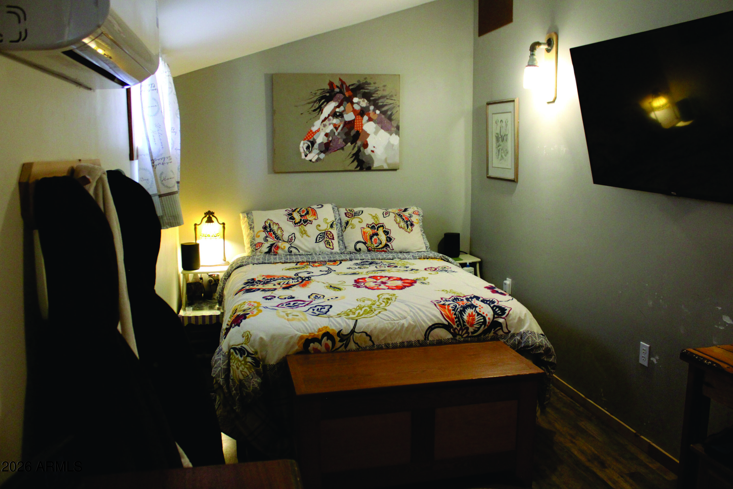 3236 North Cascabel Road Benson, AZ 85602 - Photo 13 of 63 a bedroom with a bed and a flat screen tv