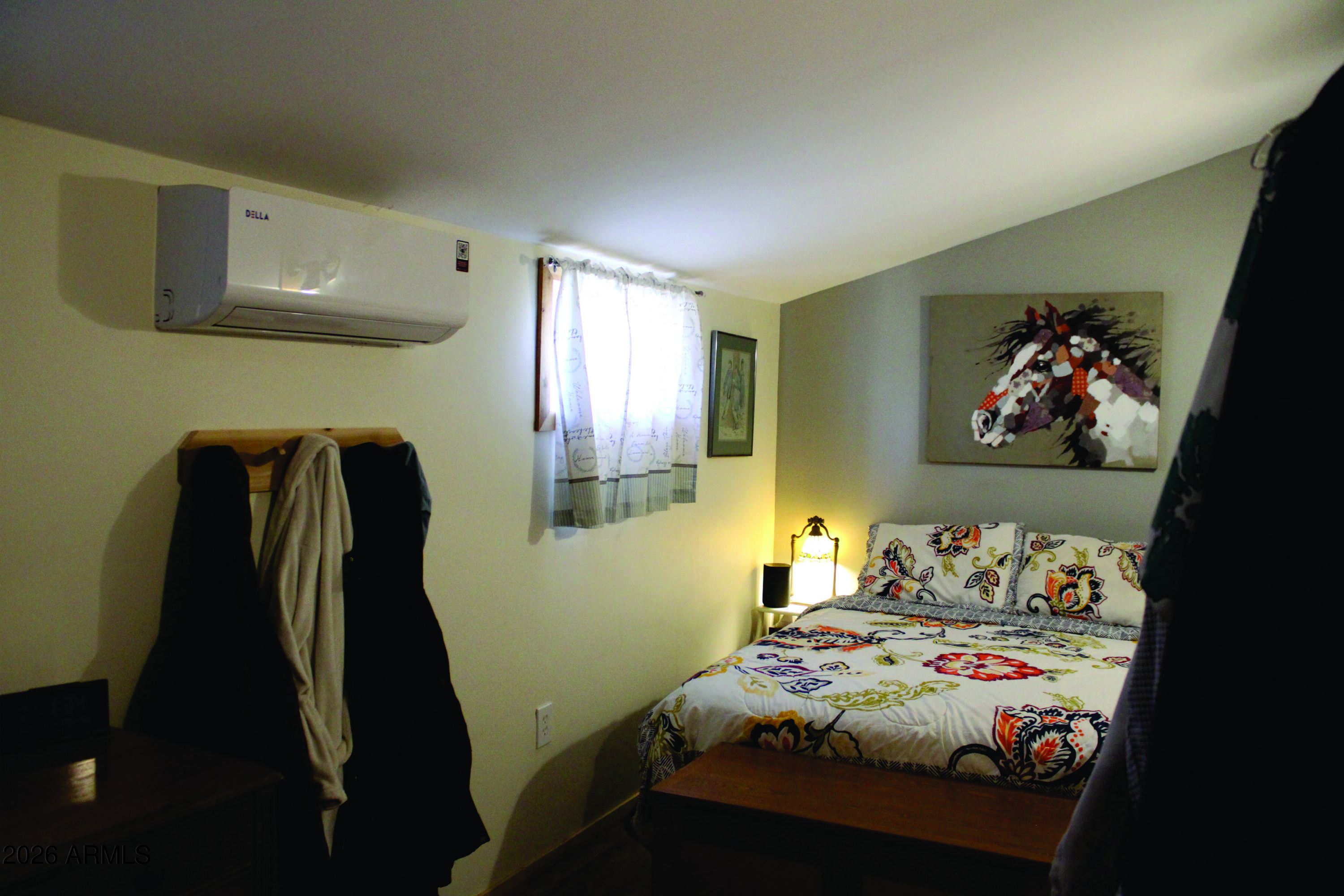 3236 North Cascabel Road Benson, AZ 85602 - Photo 15 of 63 a bedroom with a bed and a window