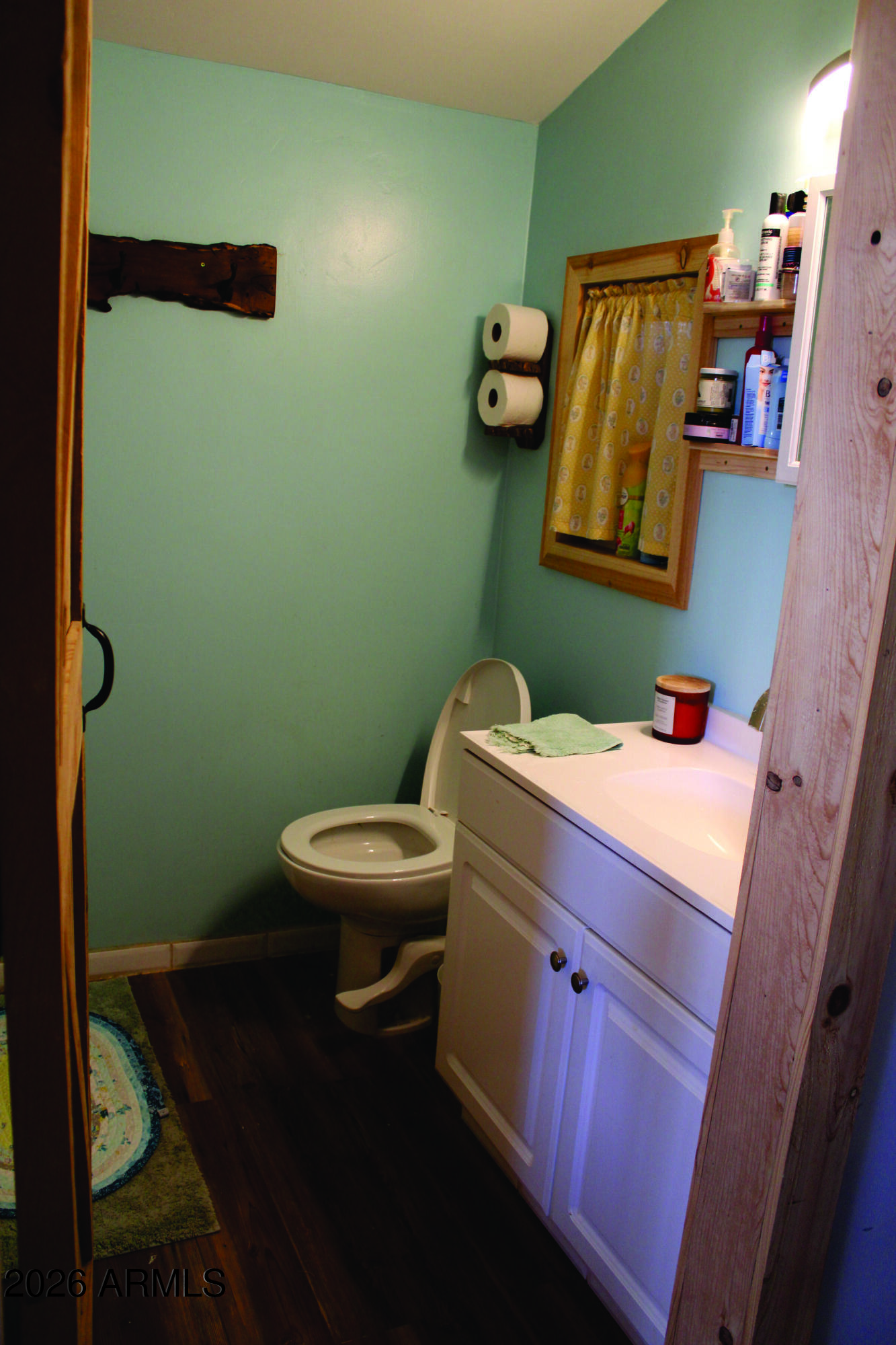 3236 North Cascabel Road Benson, AZ 85602 - Photo 16 of 63 a bathroom with a sink a toilet and a mirror