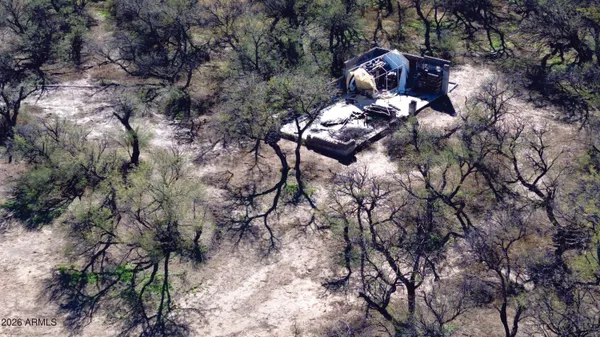 a view of a dry yard with sunset view