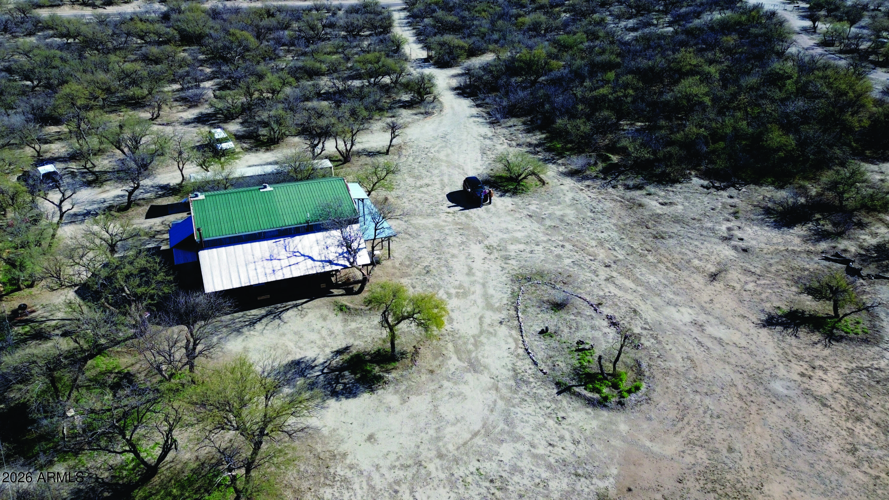 3236 North Cascabel Road Benson, AZ 85602 - Photo 28 of 63 a view of a dry yard with lots of trees