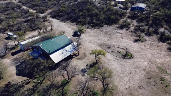 a view of a dry yard with mountains in the background