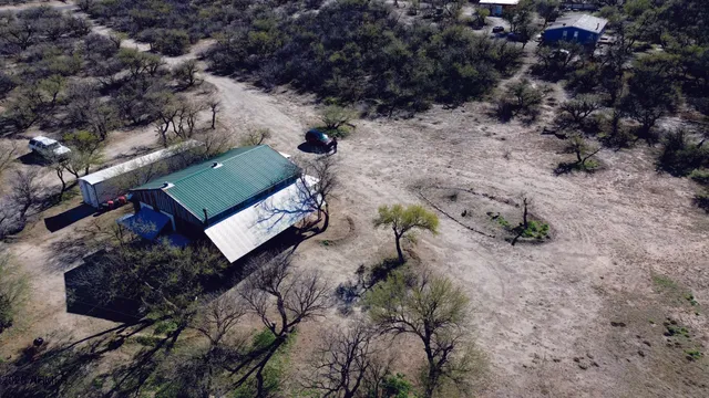a view of a dry yard with mountains in the background