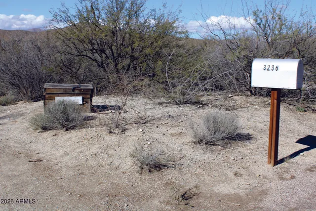 a view of a barn in the middle of a yard