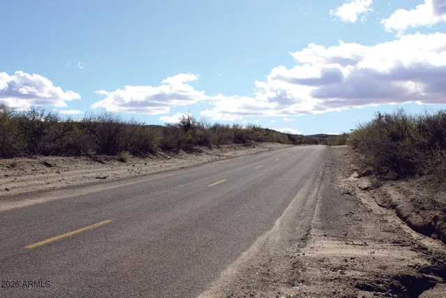 a view of a house with wooden fence