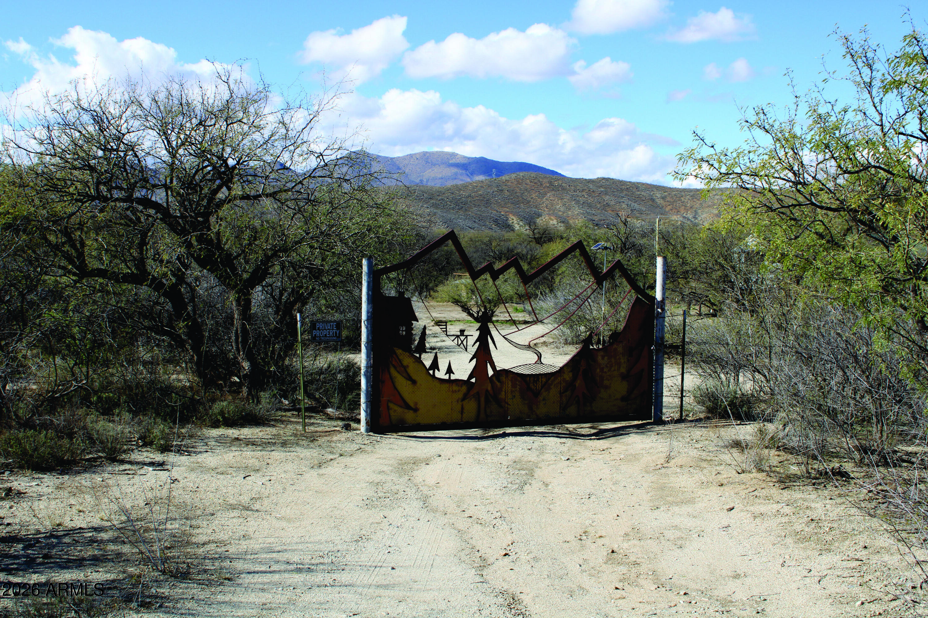 3236 North Cascabel Road Benson, AZ 85602 - Photo 4 of 63 a view of a barn in the middle of a yard