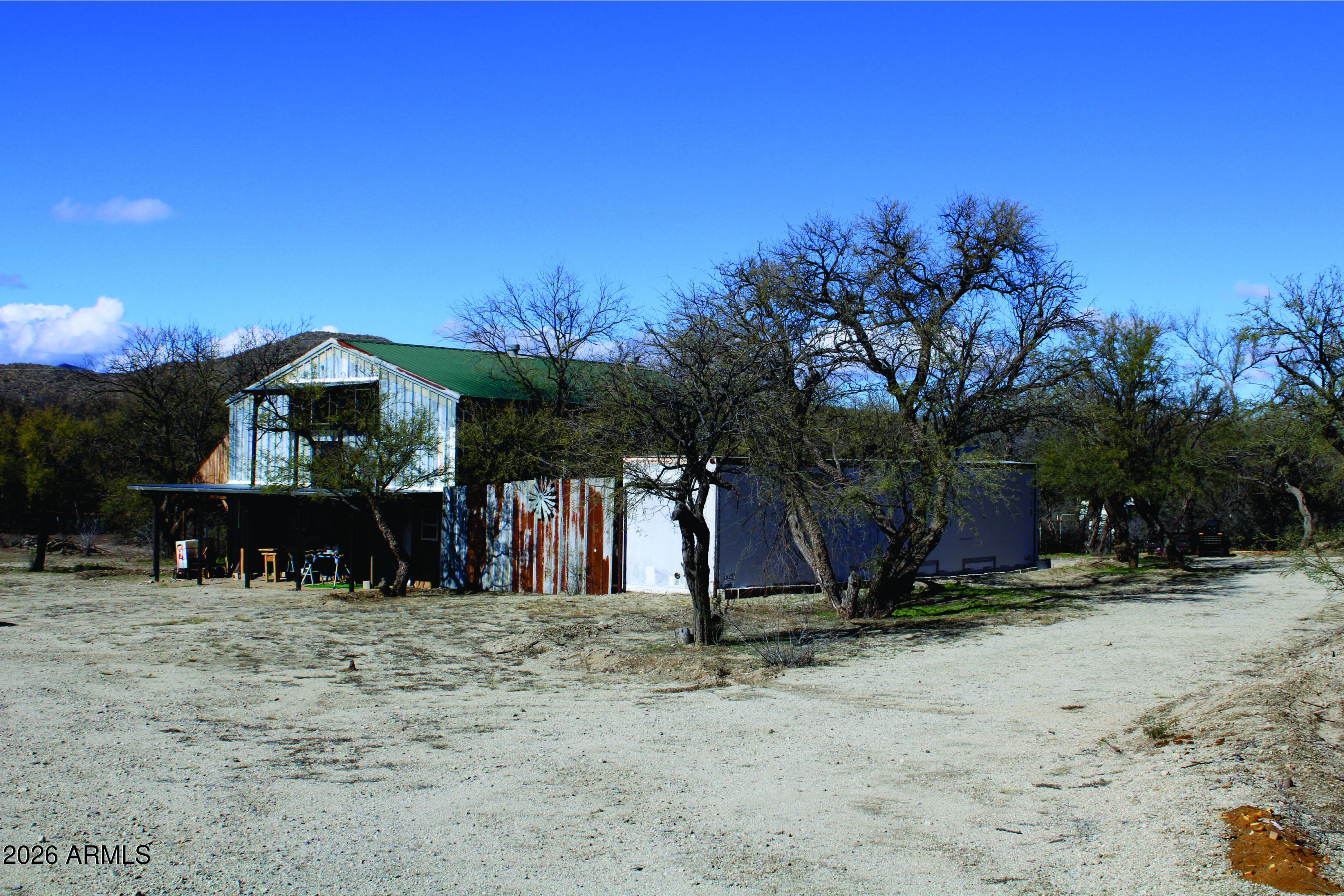 3236 North Cascabel Road Benson, AZ 85602 - Photo 45 of 63 a view of a house with a snow in the yard