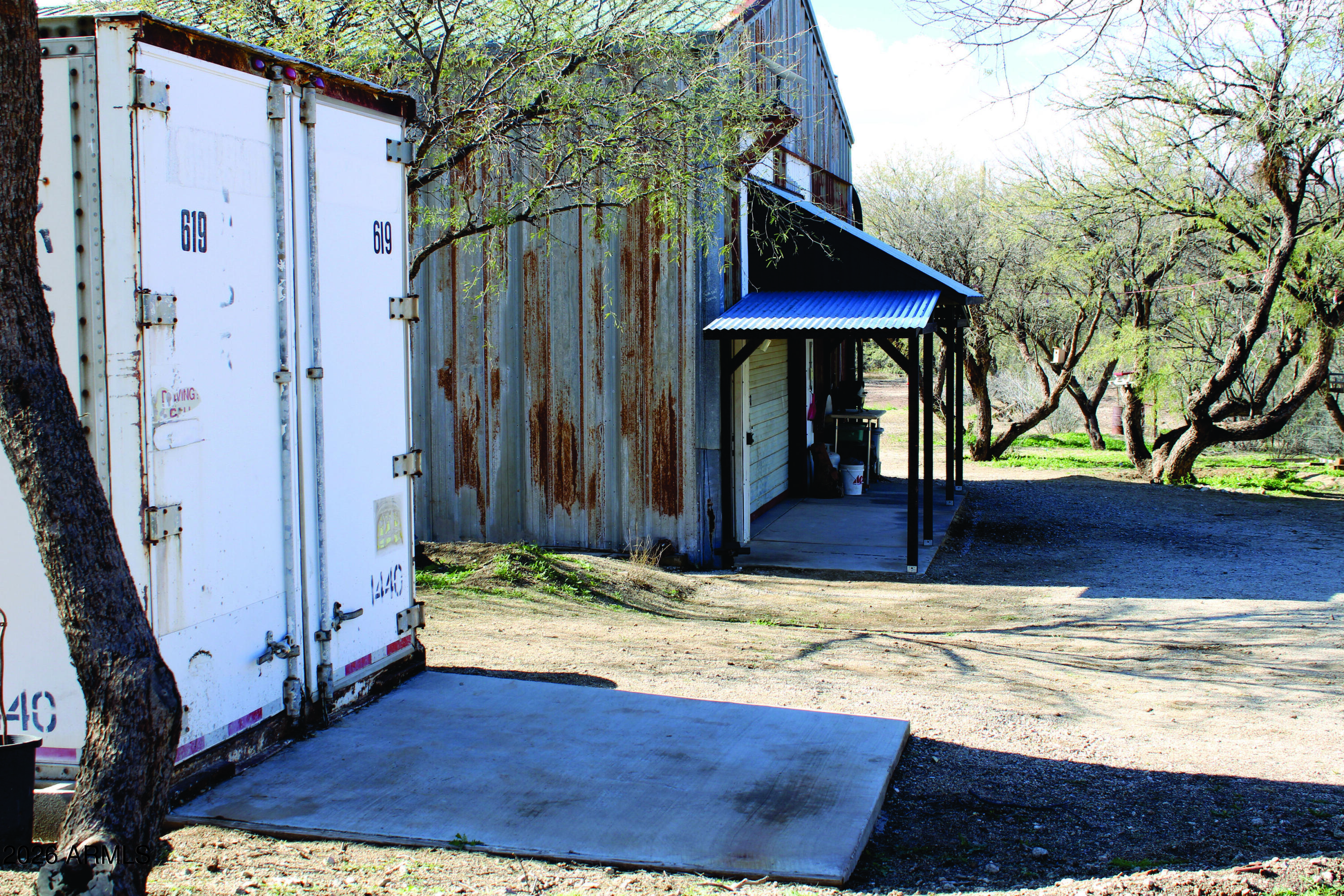 3236 North Cascabel Road Benson, AZ 85602 - Photo 46 of 63 a view of a house with small yard plants and wooden fence