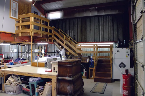 a view of a room with shelves and wooden floor