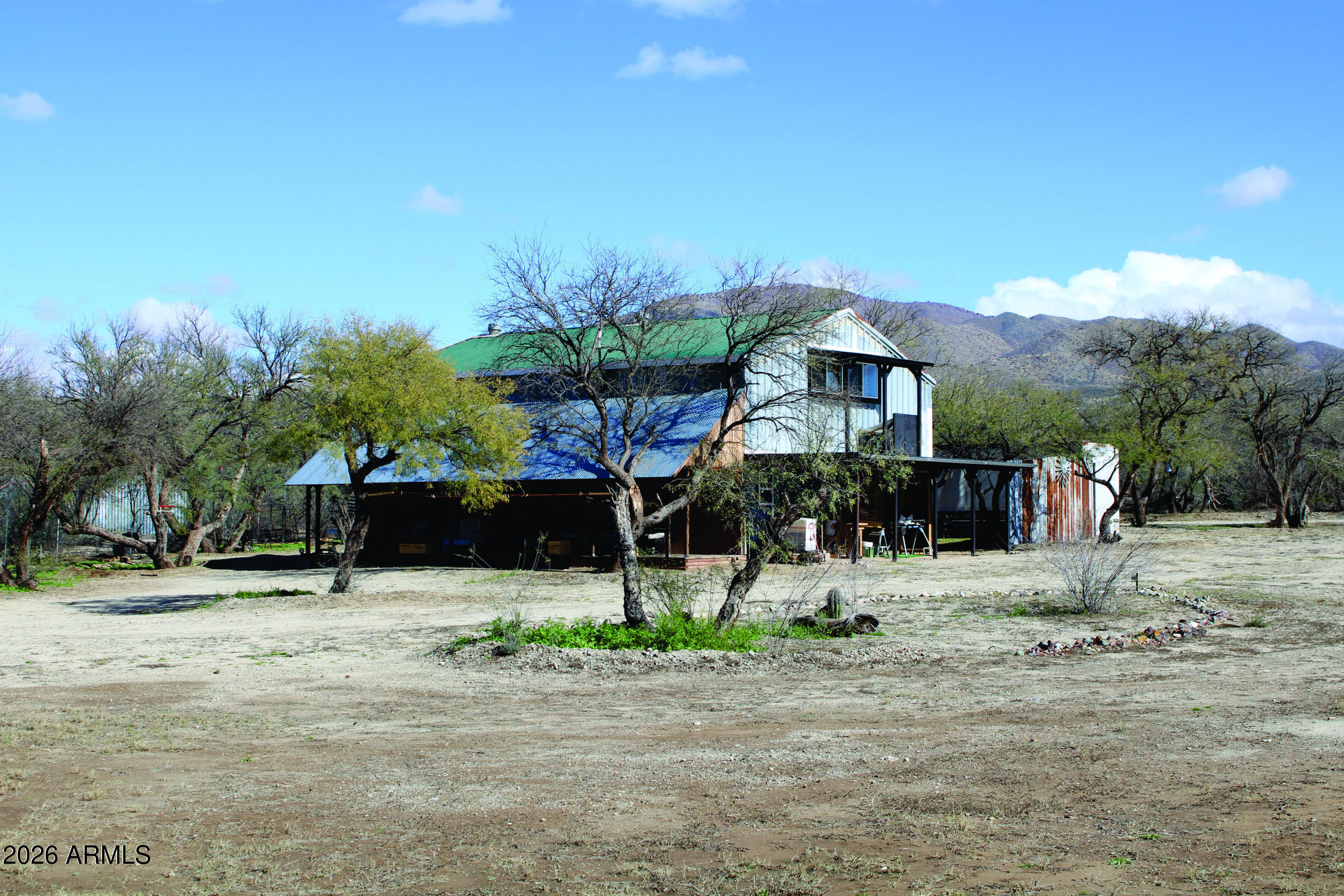 3236 North Cascabel Road Benson, AZ 85602 - Photo 58 of 63 a front view of a house with a yard and garage