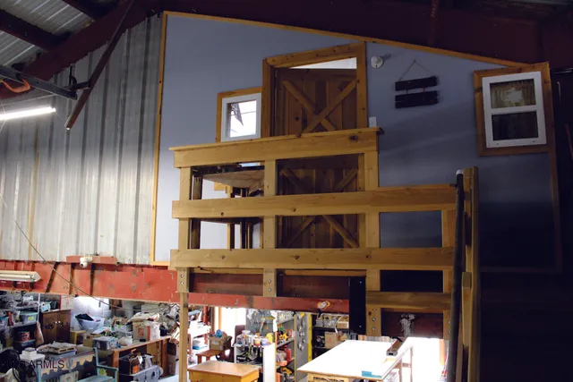 a kitchen with a wooden table and chairs