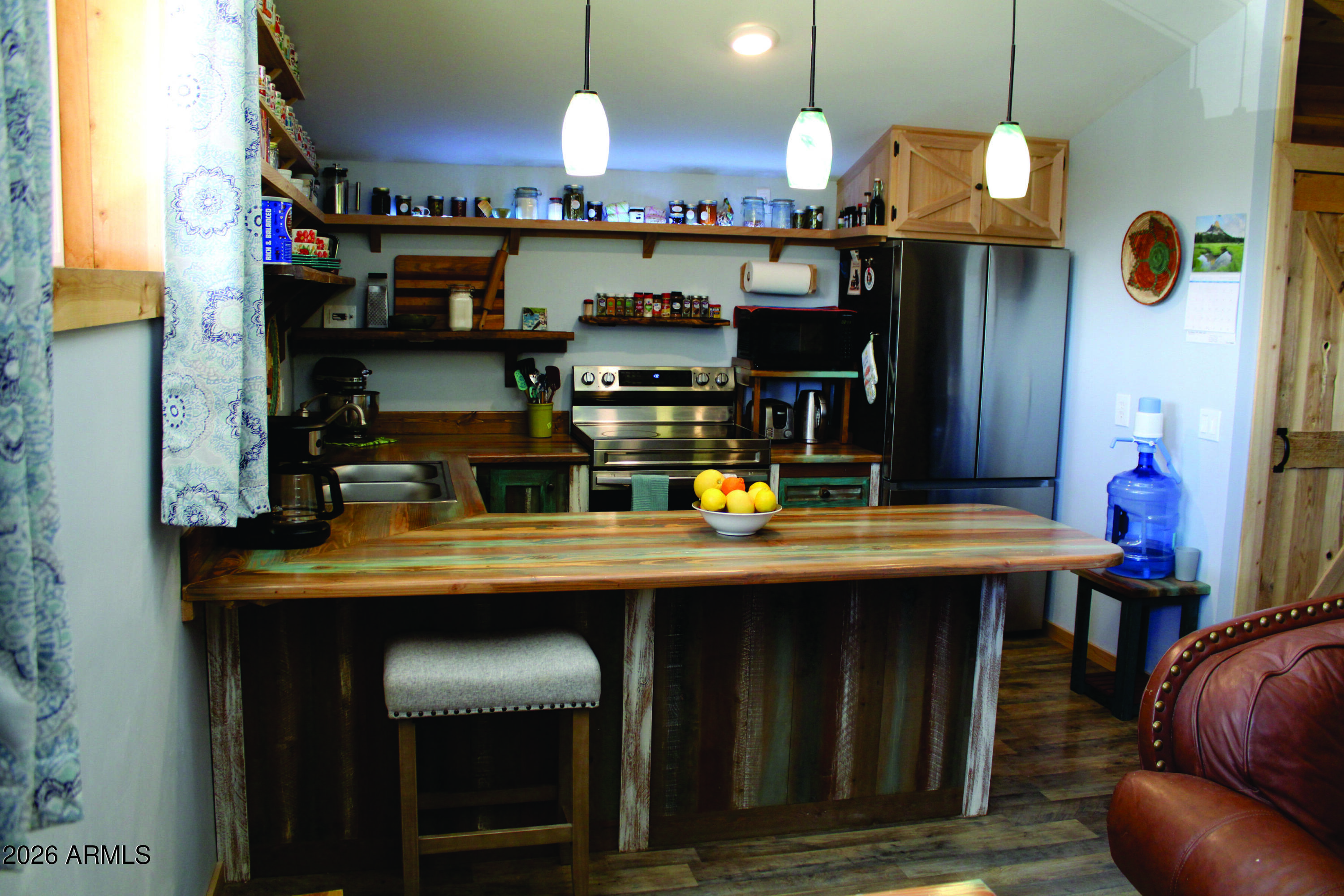 3236 North Cascabel Road Benson, AZ 85602 - Photo 9 of 63 a kitchen with a wooden table and chairs