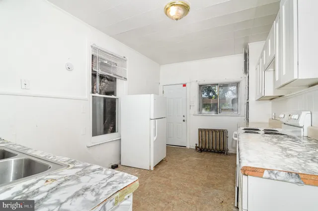 a kitchen with granite countertop a refrigerator and a stove