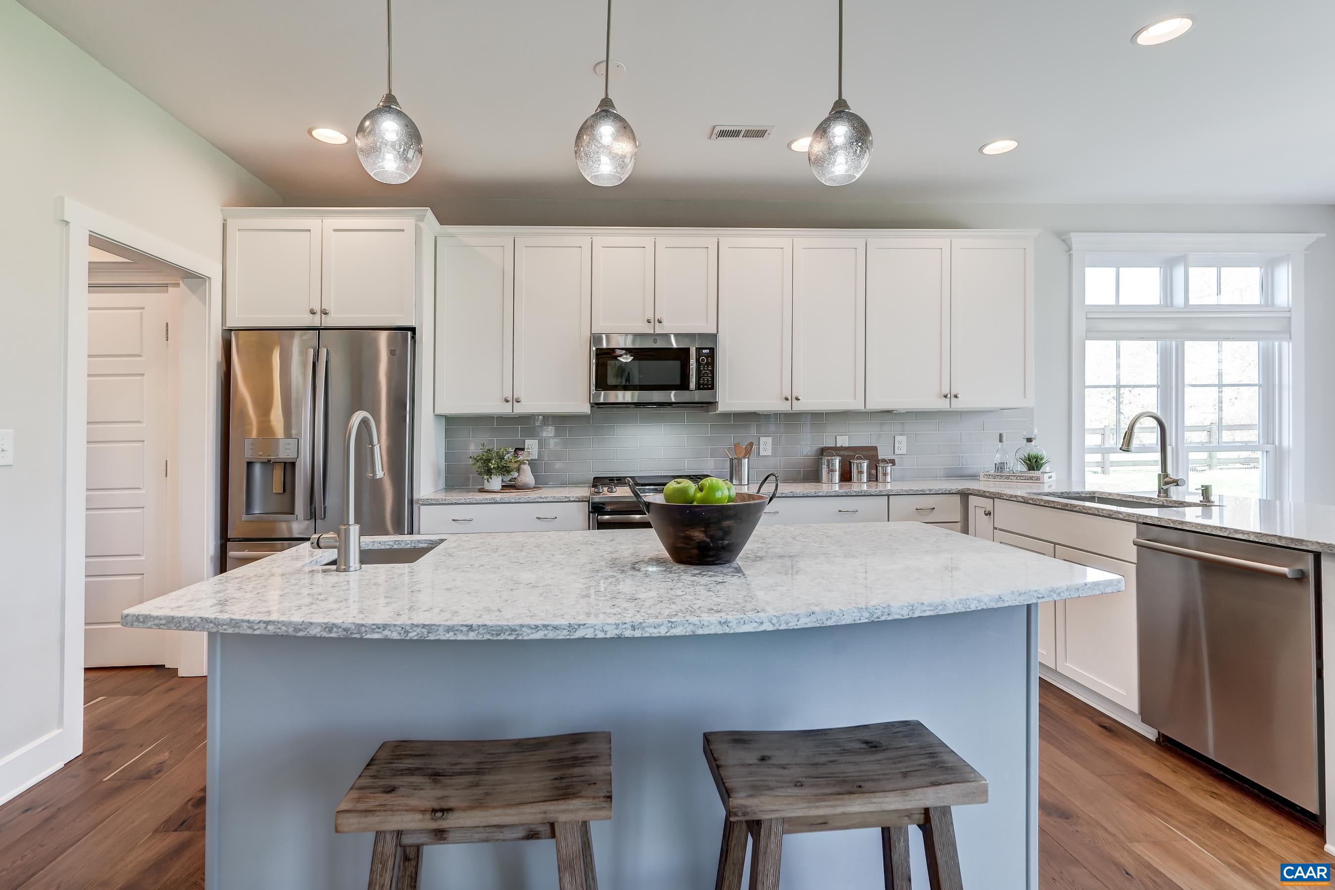 7659 Birchwood Hill Road Crozet, VA 22932 - Photo 12 of 64 a kitchen with a sink a microwave a refrigerator and cabinets