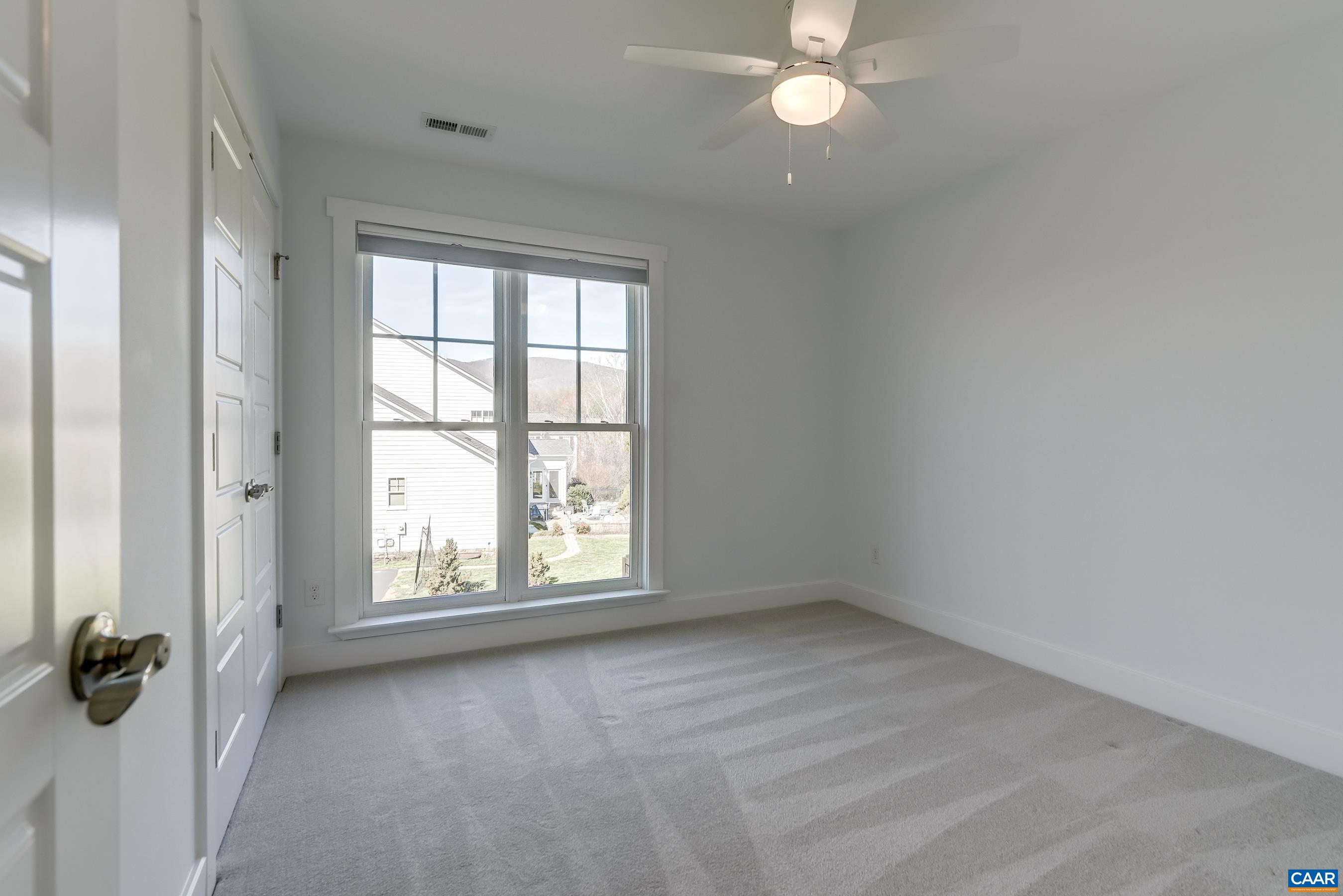 7659 Birchwood Hill Road Crozet, VA 22932 - Photo 38 of 64 an empty room with windows and fan