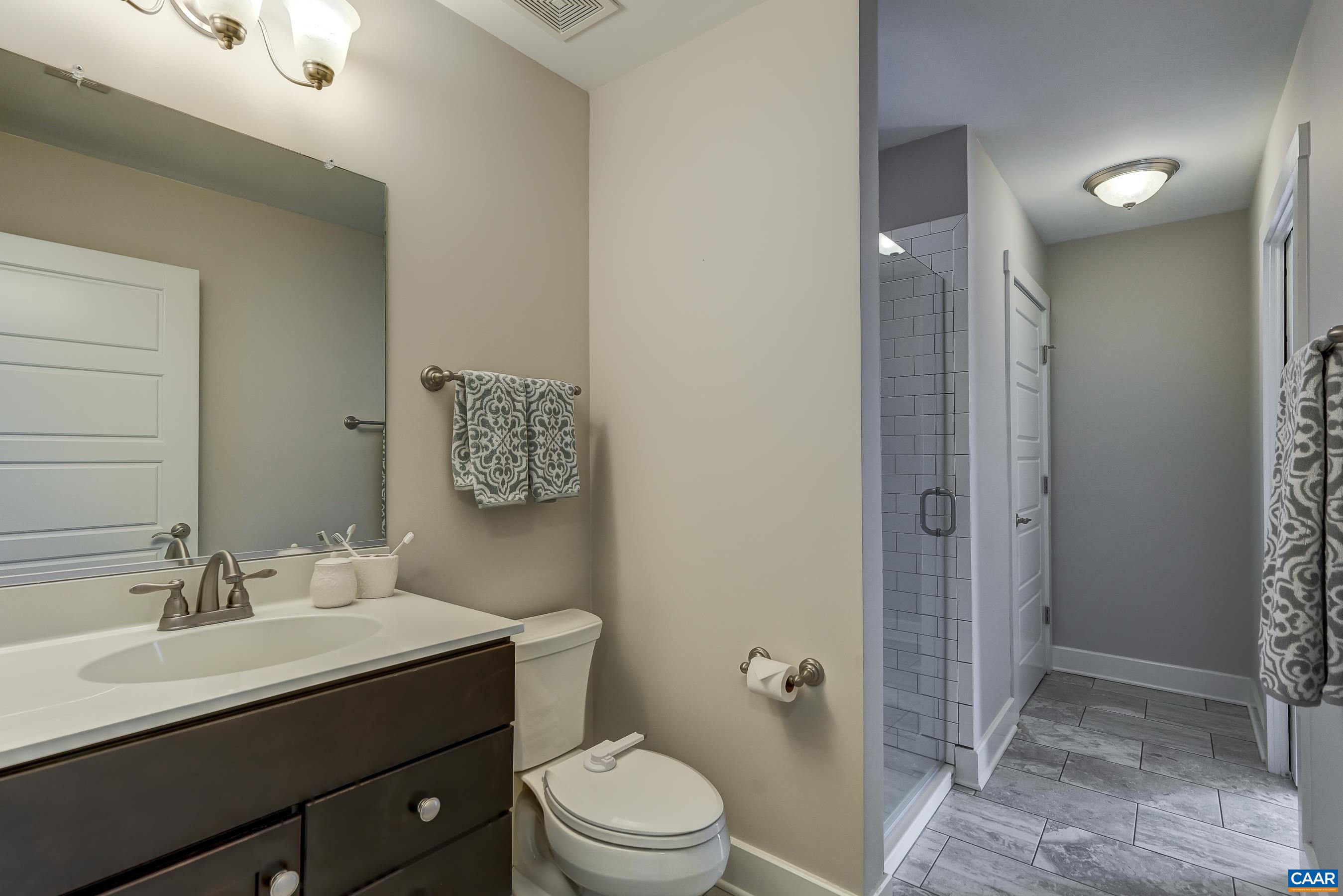 7659 Birchwood Hill Road Crozet, VA 22932 - Photo 41 of 64 a bathroom with a toilet a sink and mirror