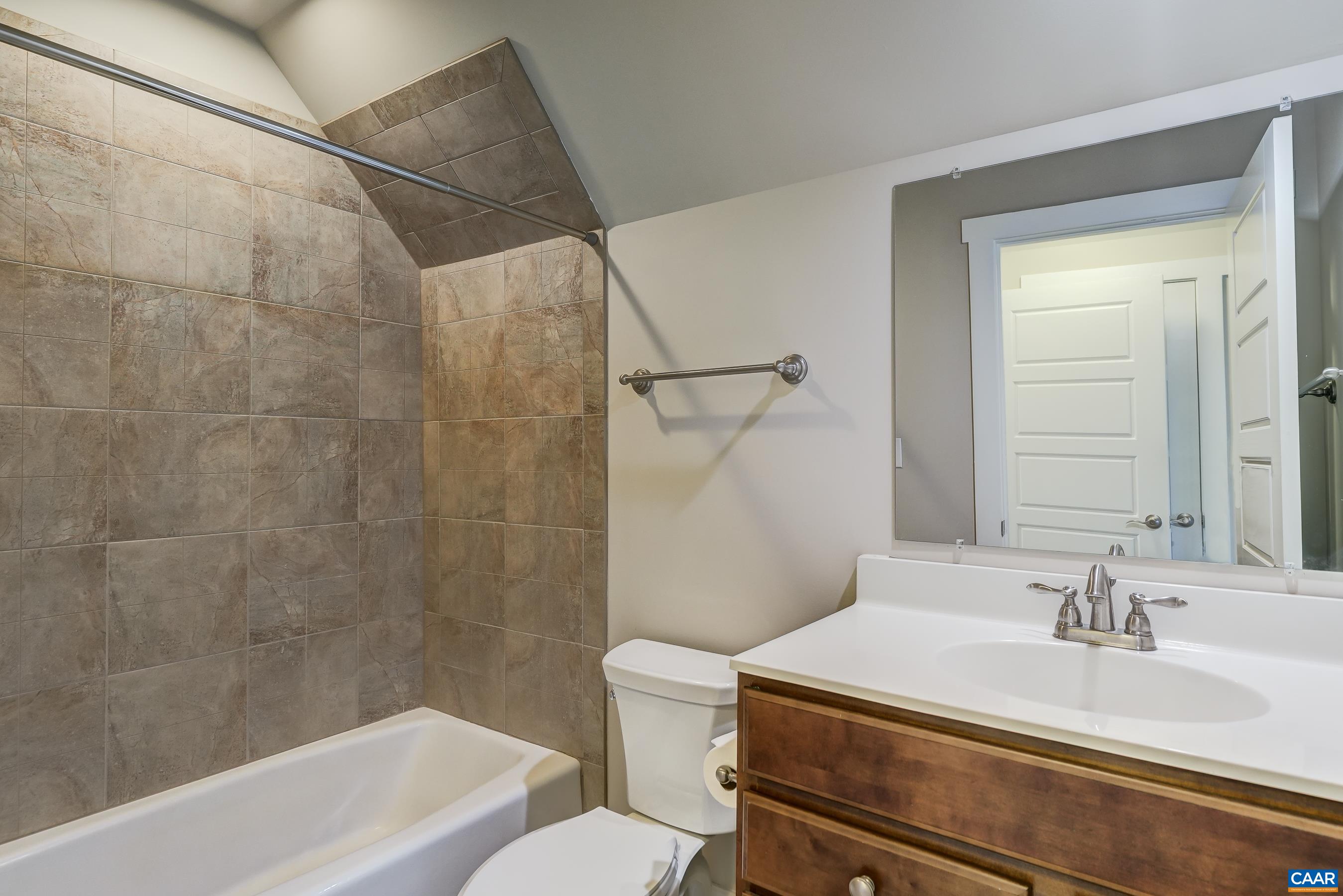 7659 Birchwood Hill Road Crozet, VA 22932 - Photo 45 of 64 a bathroom with a sink toilet vanity and shower
