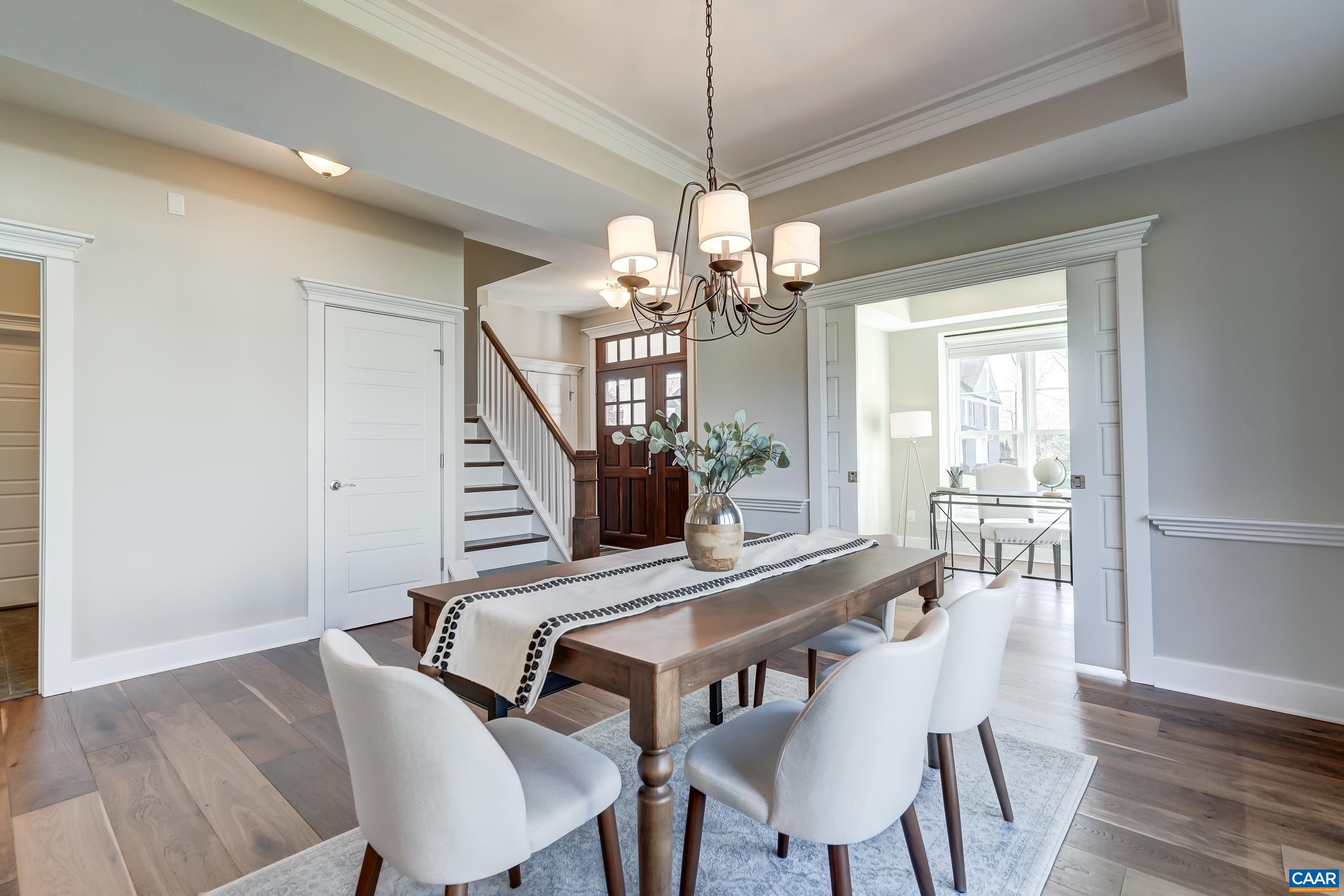 7659 Birchwood Hill Road Crozet, VA 22932 - Photo 8 of 64 a view of a dining room with furniture a chandelier and wooden floor