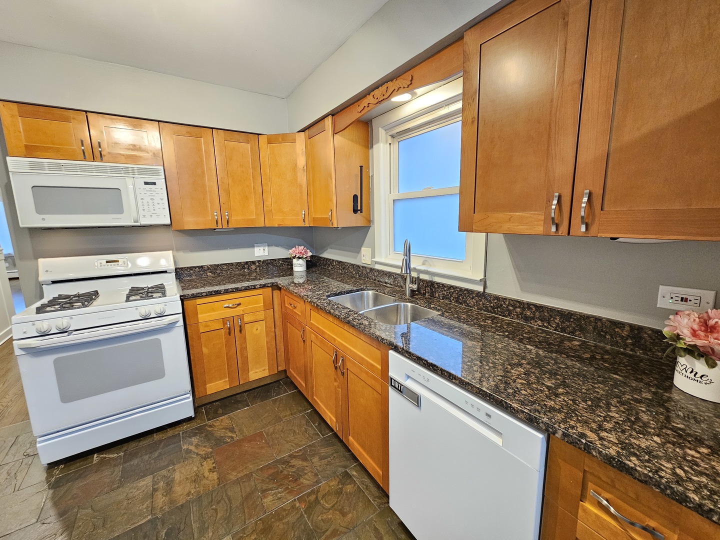 311 Maple Avenue, Unit 2 Downers Grove, IL 60515 - Photo 12 of 33 a kitchen with granite countertop a sink stove and cabinets