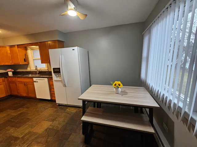 a kitchen with a wooden floor and a refrigerator