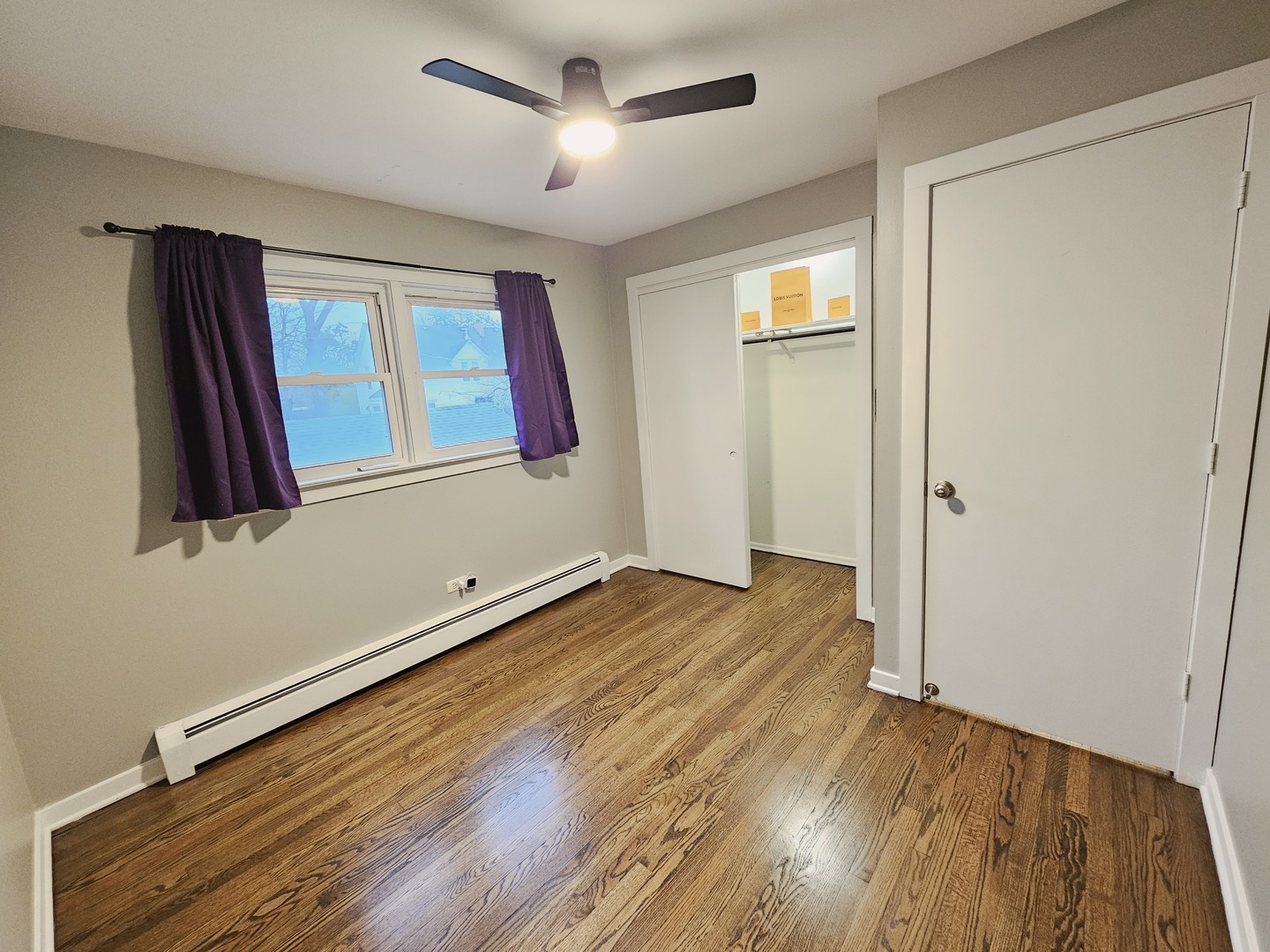 311 Maple Avenue, Unit 2 Downers Grove, IL 60515 - Photo 17 of 33 a view of an empty room with wooden floor and a window
