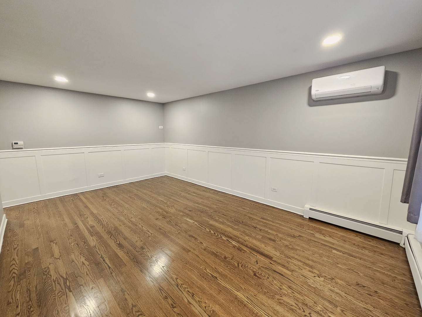 311 Maple Avenue, Unit 2 Downers Grove, IL 60515 - Photo 5 of 33 an empty room with wooden floor and windows