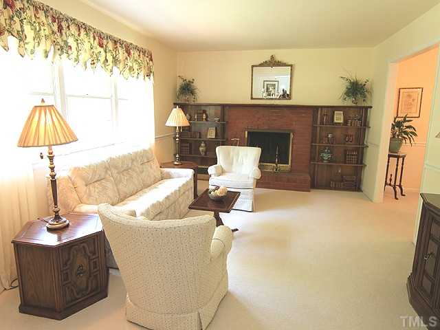 304 Ortega Road Raleigh, NC 27609 - Photo 3 of 16 a living room with a couch and a table
