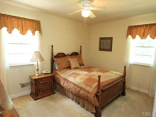 304 Ortega Road Raleigh, NC 27609 - Photo 6 of 16 a bedroom with a bed and a window
