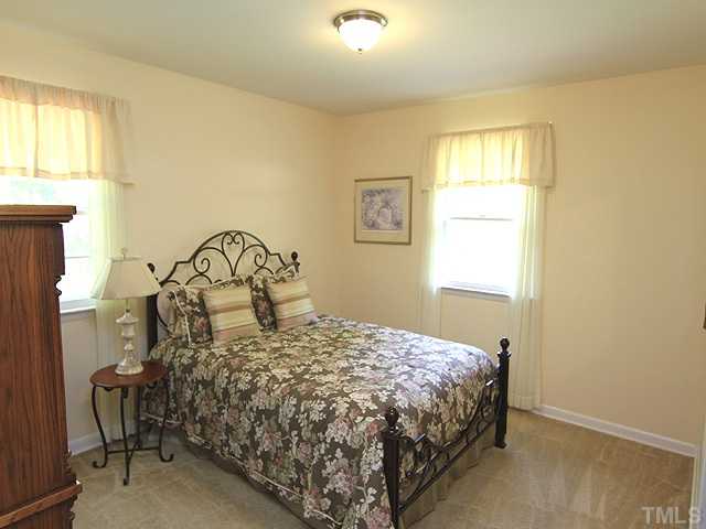 304 Ortega Road Raleigh, NC 27609 - Photo 7 of 16 a bedroom with a bed and a window