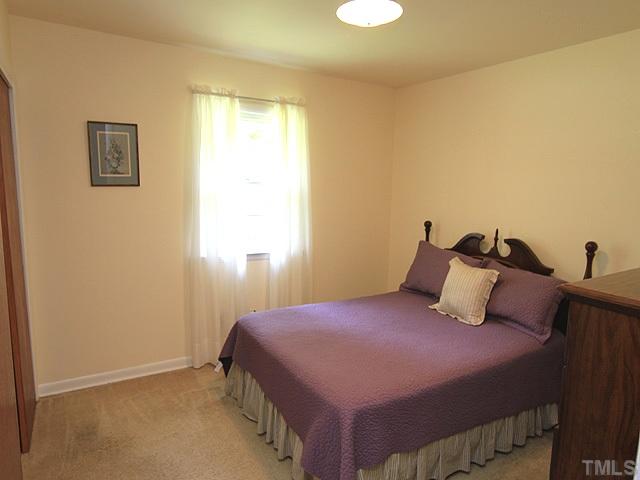 304 Ortega Road Raleigh, NC 27609 - Photo 8 of 16 a bedroom with a bed and window