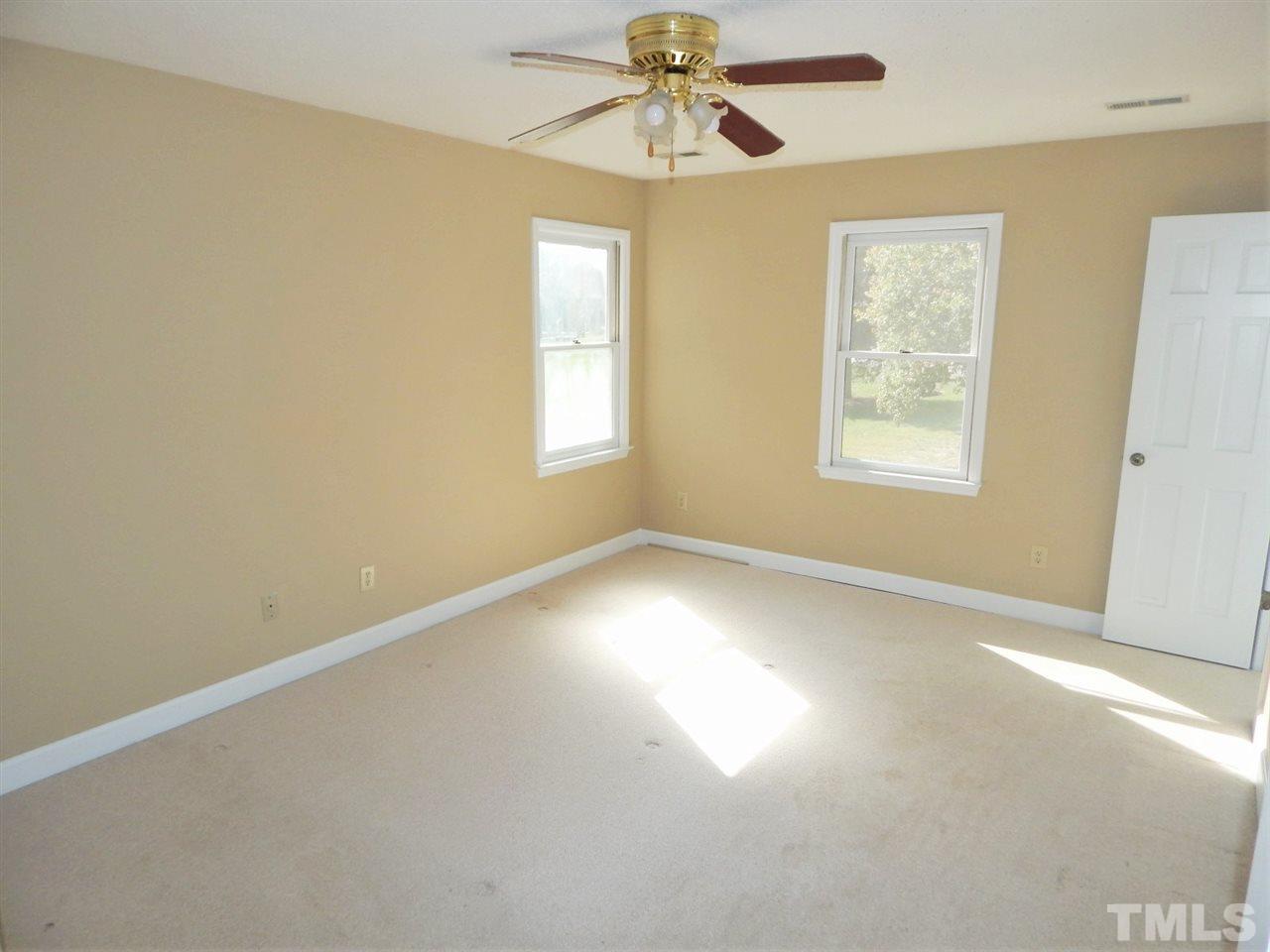 4829 Draper Road Raleigh, NC 27616 - Photo 11 of 25 an empty room with windows and fan