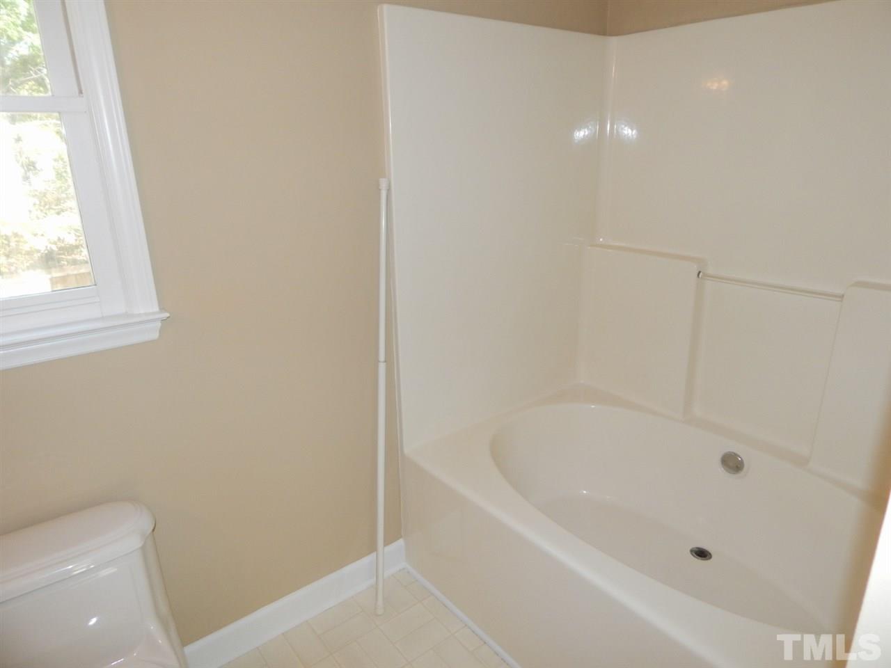 4829 Draper Road Raleigh, NC 27616 - Photo 13 of 25 a white bath tub sitting next to a toilet